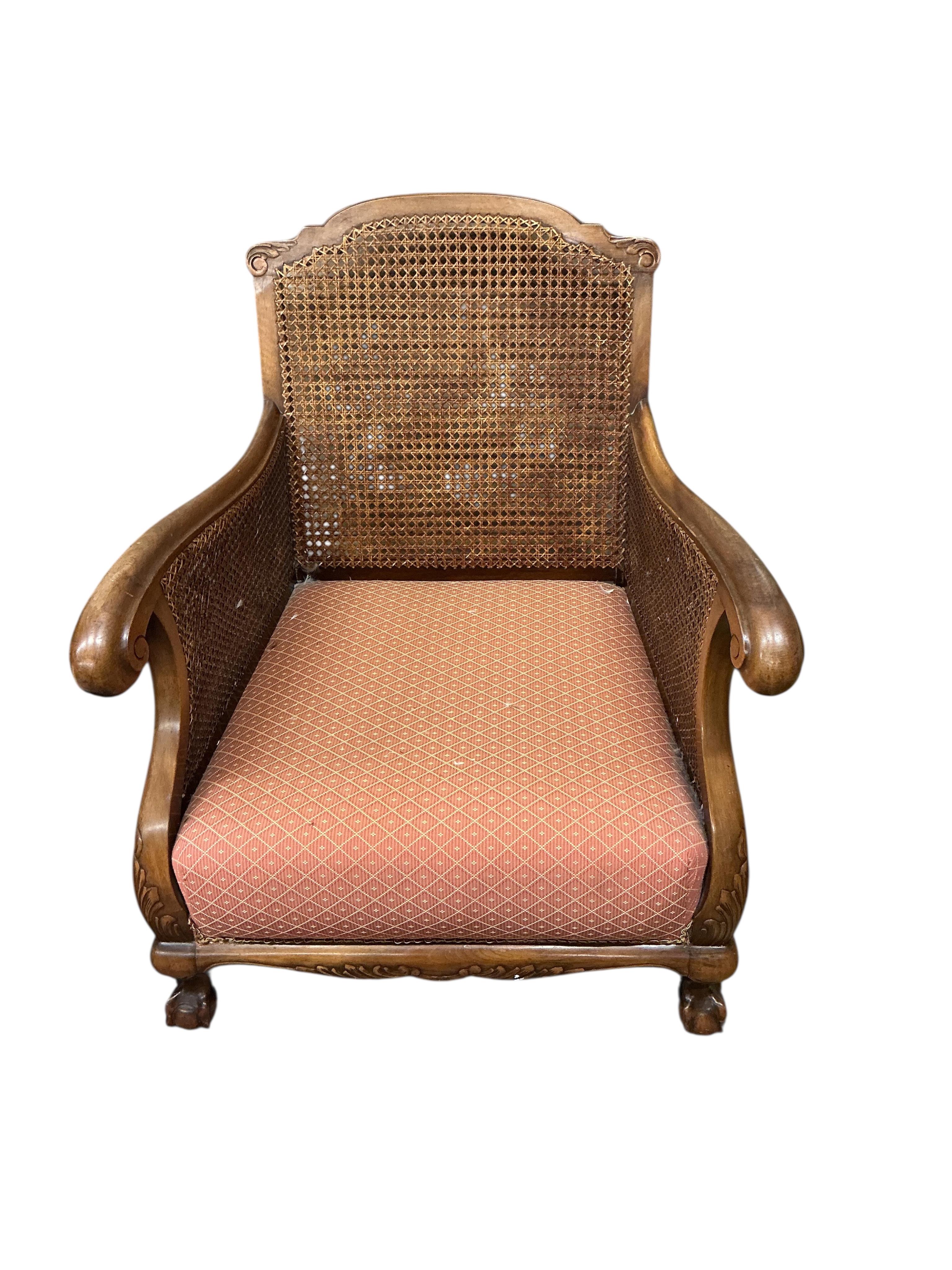 An early 20th century mahogany three piece bergere suite